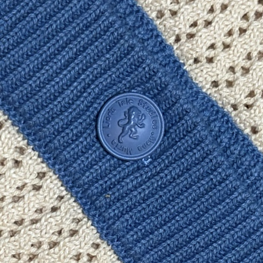 lion's tale studios knitwear knitted anti-logo no logo shirt light blue cream color button lion mena muria een voor allen voor een maluku molukken vertical stripes soft knit, breathable knitwear soft knit breathable knitwear cotton-blend quiet luxury, no-logo fashion, minimalist fashion Moluccan roots, heritage fashion, symbolic buttons unisex shirt, men’s knit shirt, women’s knitwear top cream and blue shirt, button-up designed in the Netherlands, Maluku inspired