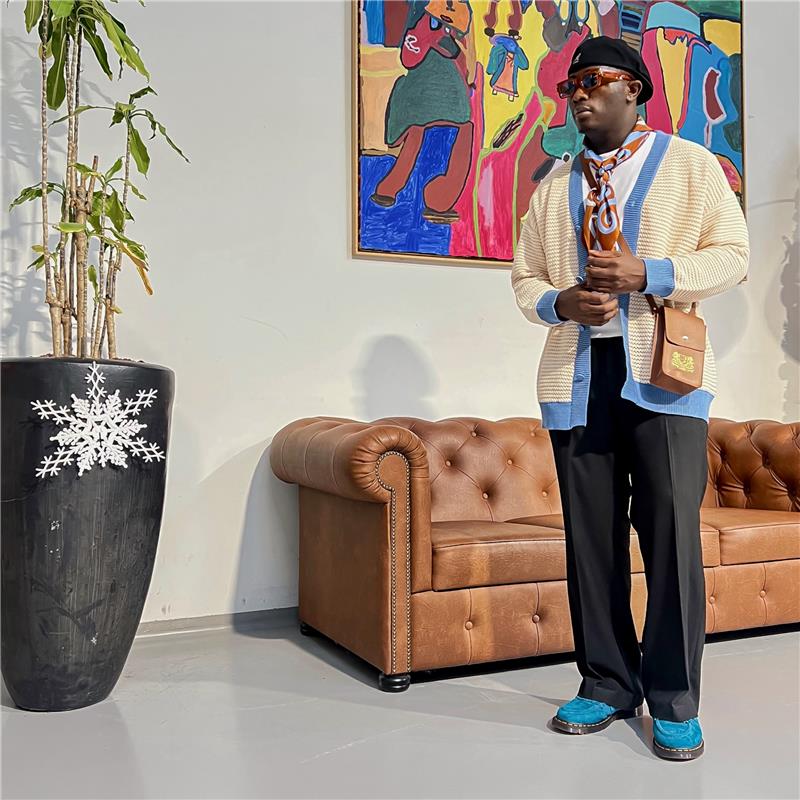 lion's tale studios knitwear knitted anti-logo no logo shirt light blue cream color button lion mena muria een voor allen voor een maluku molukken vertical stripes soft knit, breathable knitwear soft knit breathable knitwear cotton-blend quiet luxury, no-logo fashion, minimalist fashion Moluccan roots, heritage fashion, symbolic buttons unisex shirt, men’s knit shirt, women’s knitwear top cream and blue shirt, button-up designed in the Netherlands, mini bag leather eyewear cardigan pure silk loafers keys